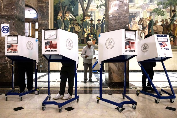 Voters cast their ballots at the Bronx County Supreme Court...