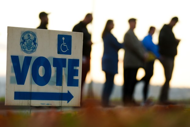 Voters wait in line to cast their ballots at Scranton...