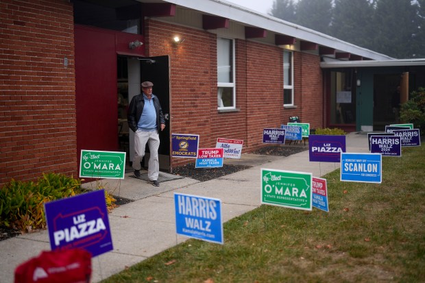 A man departs a polling place, Tuesday, Nov. 5, 2024,...