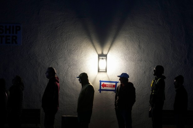 Voters stand in line outside a polling place at Madison...