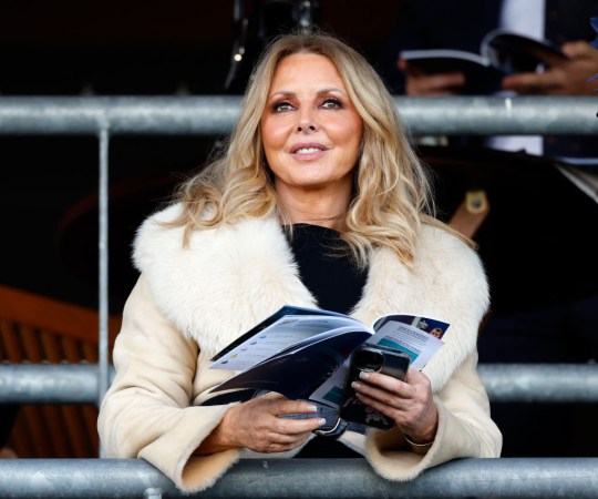 Carol Vorderman at Ascot wearing a black dress and a cream fur coat