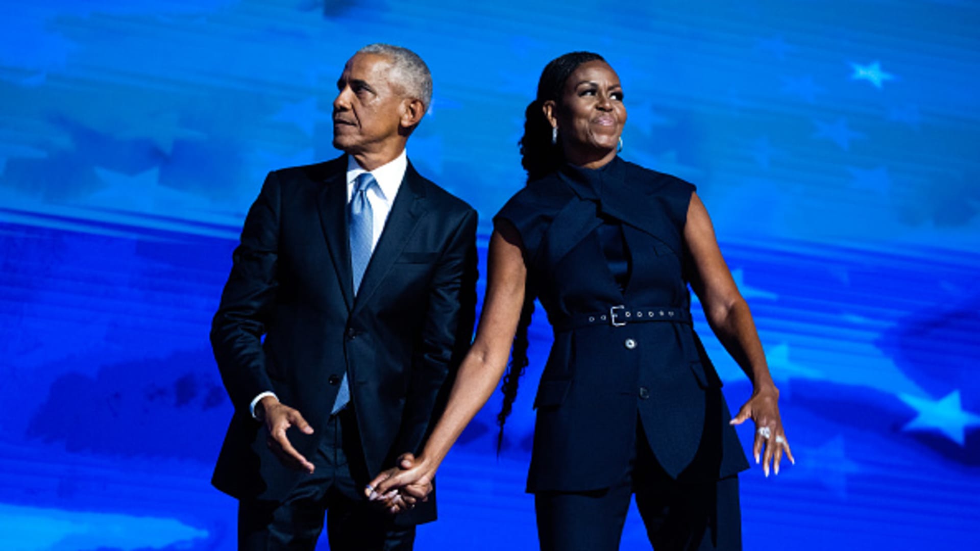 Former President Barack Obama and former first lady Michelle Obama appear on stage on the second night of the Democratic National Convention at the United Center in Chicago, Ill., on Tuesday, August 20, 2024. 