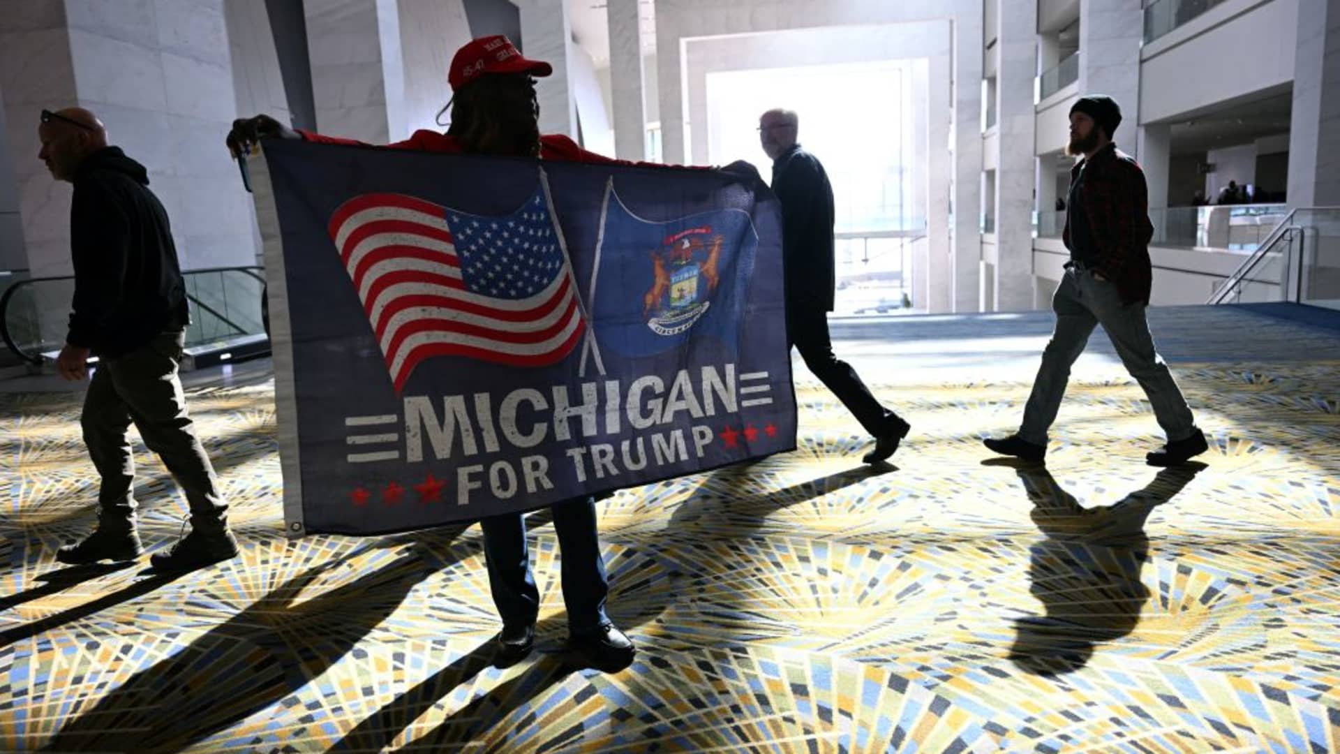 People arrive for the campaign rally of former US President and Republican presidential candidate Donald Trump at Huntington Place in Detroit, Michigan, on October 18, 2024.