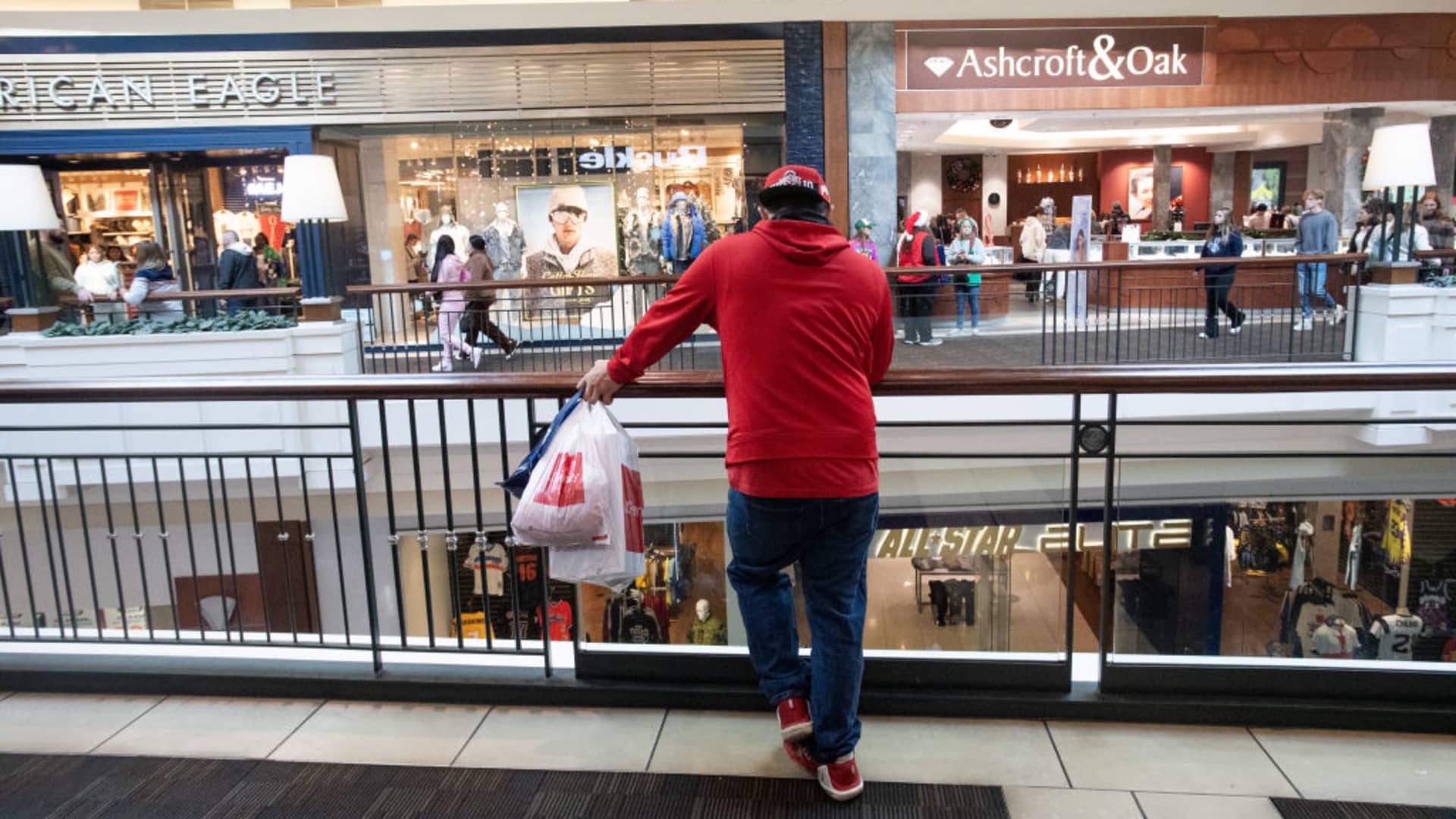 A shopper carries bags at the Polaris Fashion Place mall on Black Friday in Columbus, Ohio.