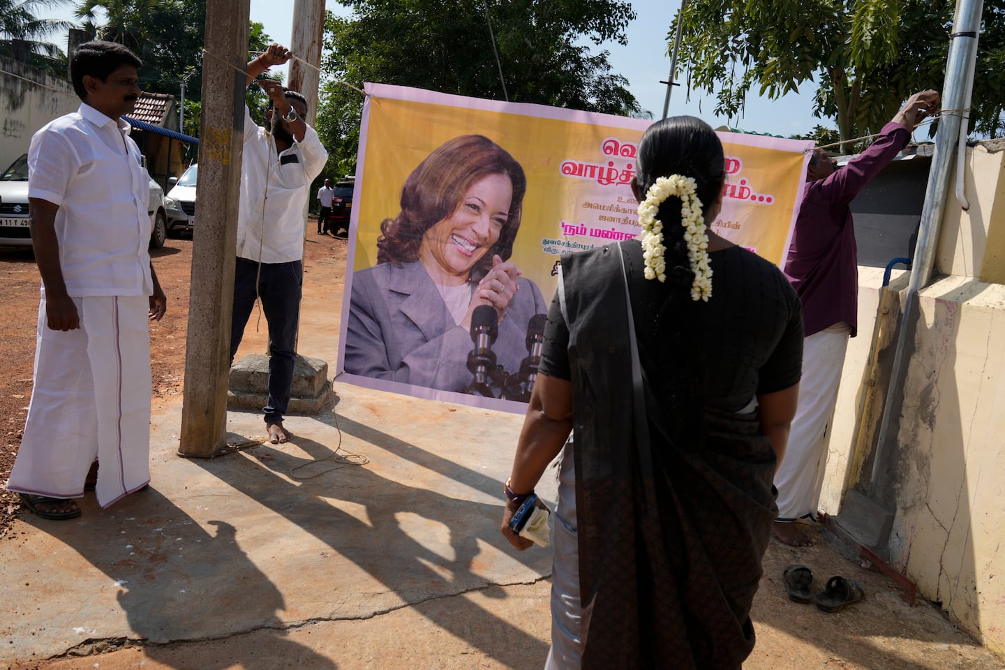 Villagers tie a banner featuring Democratic presidential nominee Vice President Kamala Harris outside a temple in Thulasendrapuram, the ancestral village of Harris, in Tamil Nadu state, India, on Nov. 5.