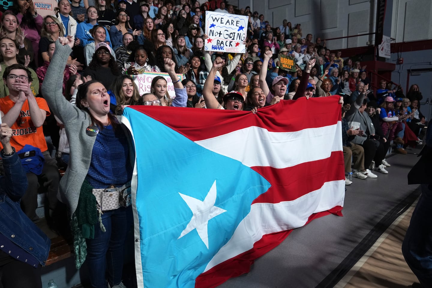 Attendees holding the flag of Puerto Rico cheer as Allentown, Pa. Mayor Matt Tuerk speaks during a campaign rally for Democratic presidential nominee Vice President Kamala Harris in Memorial Hall at Muhlenberg College in Allentown, Pa., Monday, Nov. 4, 2024.