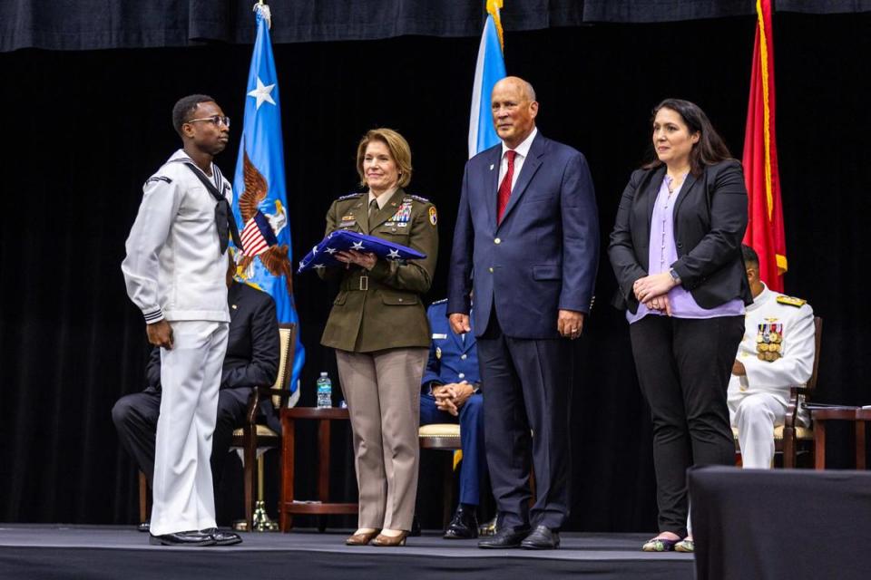 From left to right, U.S. Army Gen. Laura J. Richardson, her husband Lt. Gen. James M. Richardson, and their daughter Lauren Richardson as the U.S. Army General is presented a retirement flag during the change of command ceremony at the U.S. Southern Command in Doral.