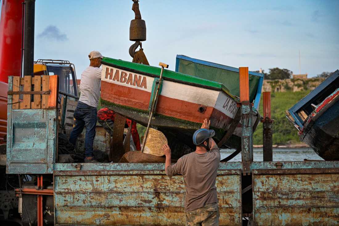 Fishermen remove their boats from the water on Tuesday ahead of the arrival of Hurricane Rafael in Havana. Cuba was bracing for Rafael, which is expected to make landfall on the island on Wednesday, compounding the misery wrought by a massive blackout and Hurricane Oscar.