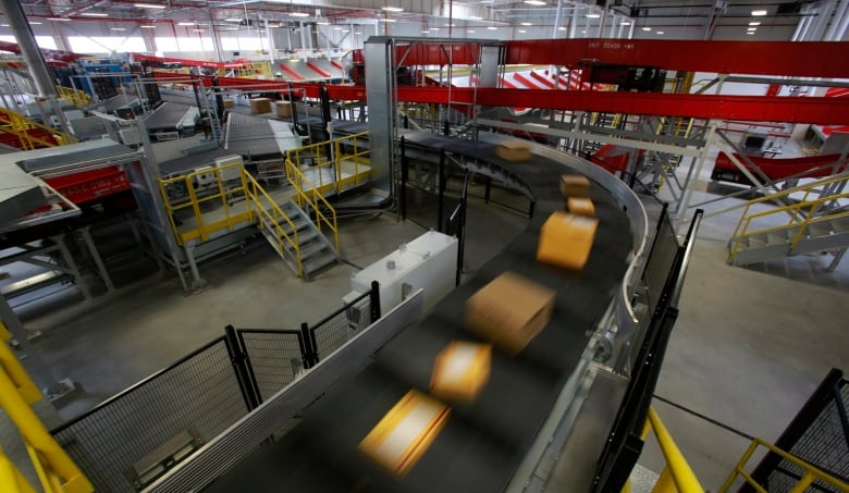 Packages move along a conveyor belt at a DHL hub. Incendiary devices disguised as personal massagers were sent from Lithuania to addresses across Europe. In what authorities allege was a 'test run' for eventual attacks against planes bound for North America.