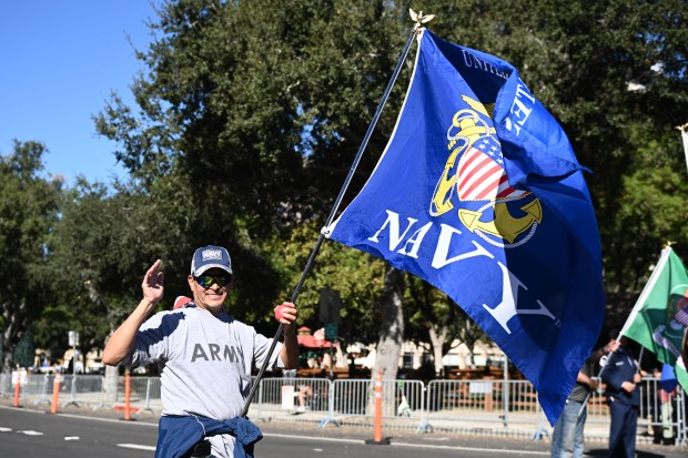 Daniel Castro, a 25-year veteran, marches during the Veterans Day...