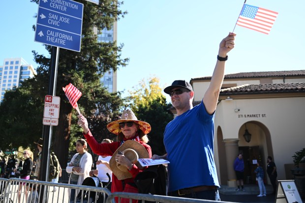 Marilyn Reid and Jess Reid cheer on the veterans during...