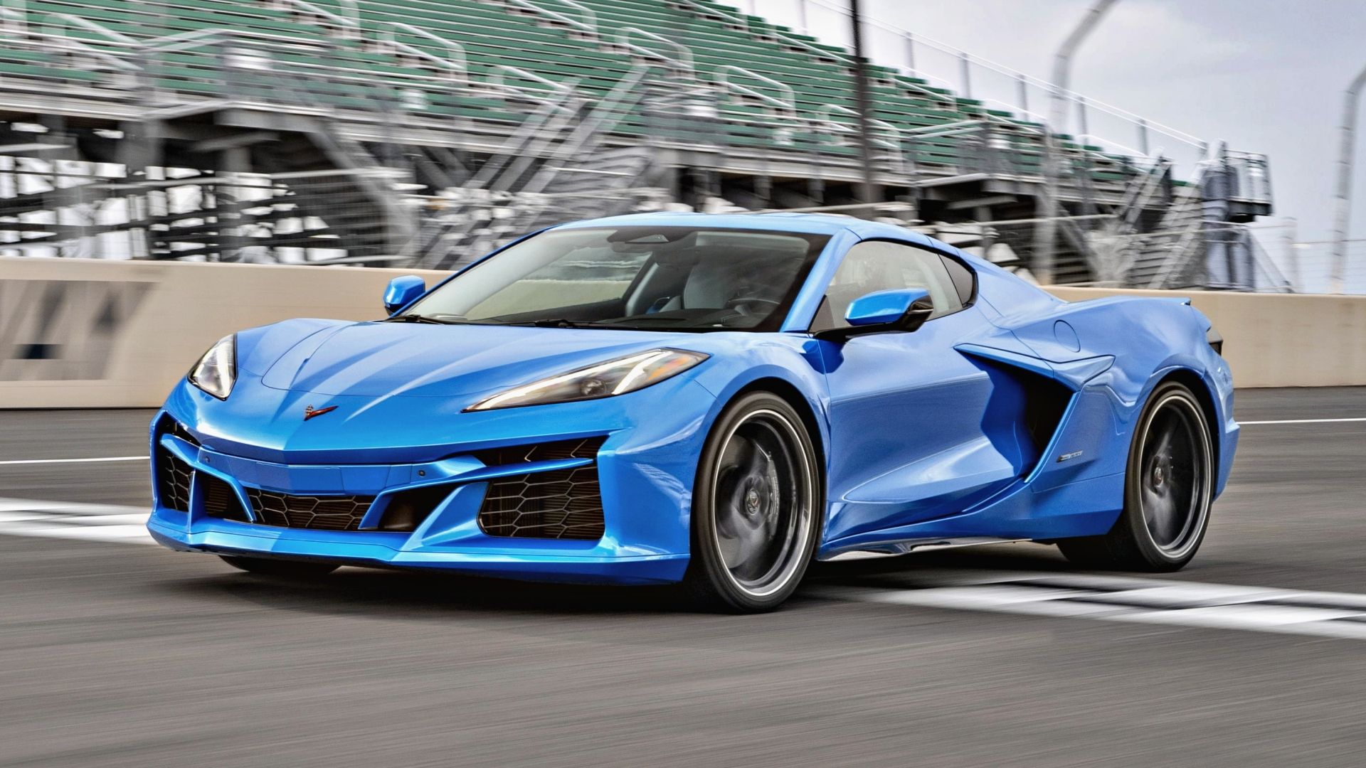 Blue 2024 Chevrolet Corvette E-Ray driving on a track