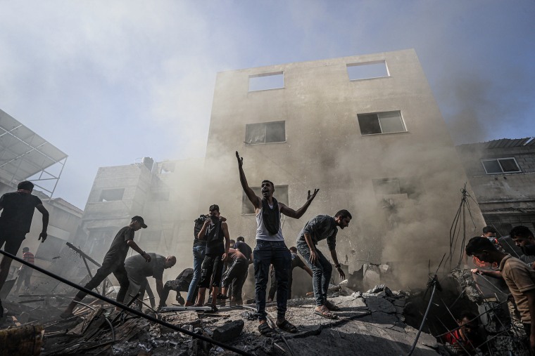 Civil defense teams and locals carry out search and rescue operations after an Israeli attack hits Shaqwra family apartment in Khan Yunis, Gaza on Nov. 6, 2023.