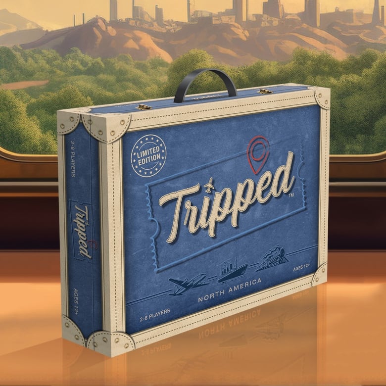 A board game box with a handle, meant to look like a suitcase. It says tripped on the box.