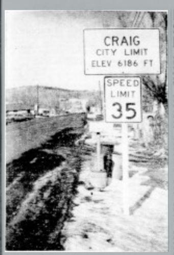 Historical photo of sign giving speed limit and elevation of the town of Craig, from a 1964 newspaper article