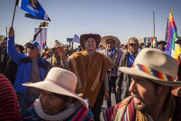 Morales dressed in traditional clothing as he participates on a march.