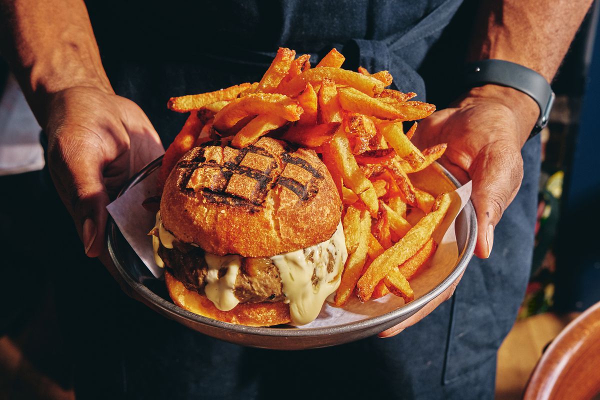 The Sailor burger with melted onions, cheddar cheese, and fries