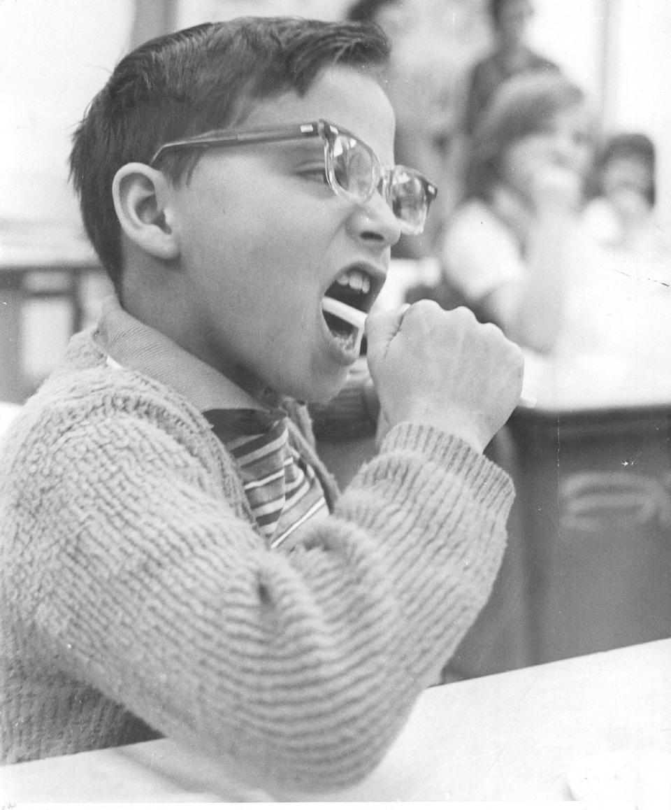 retro photo of kid brushing teeth