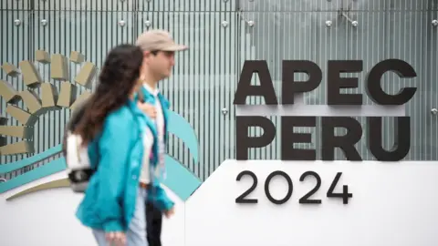 Reuters People walk at the venue of the Asia-Pacific Economic Co-operation (Apec) summit in Lima, Peru