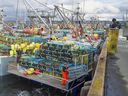 Fishermen load their traps in Lower West Pubnico, N.S., on Nov. 28, 2020. 