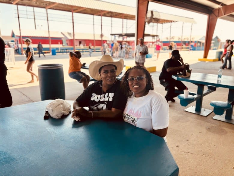 Michelle Clark and Candice Sims have been attending the rodeo for years. They’ve endured racist comments, but love the event as a way to support those incarcerated. (Adam Mahoney/Capital B)