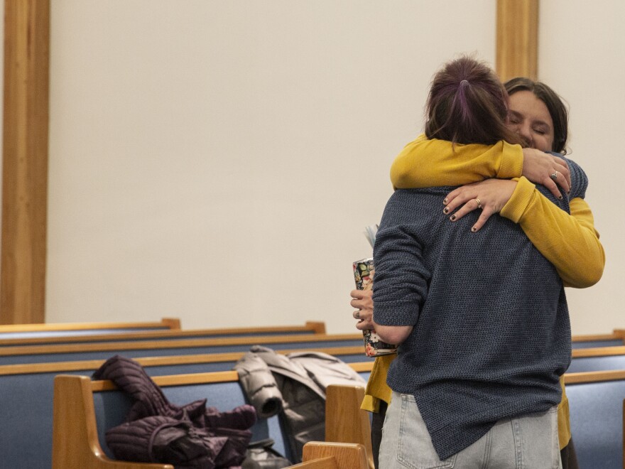 Choir members hug at practice the day after Election Day.