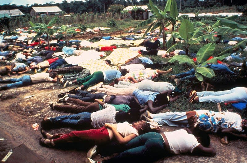 FILE - This November 1978 file photo shows the bodies of Peoples Temple mass suicide victims led by Jim Jones in Jonestown, Guyana. Dozens of Peoples Temple members in Guyana survived the mass suicides and murders of more than 900 because they had slipped