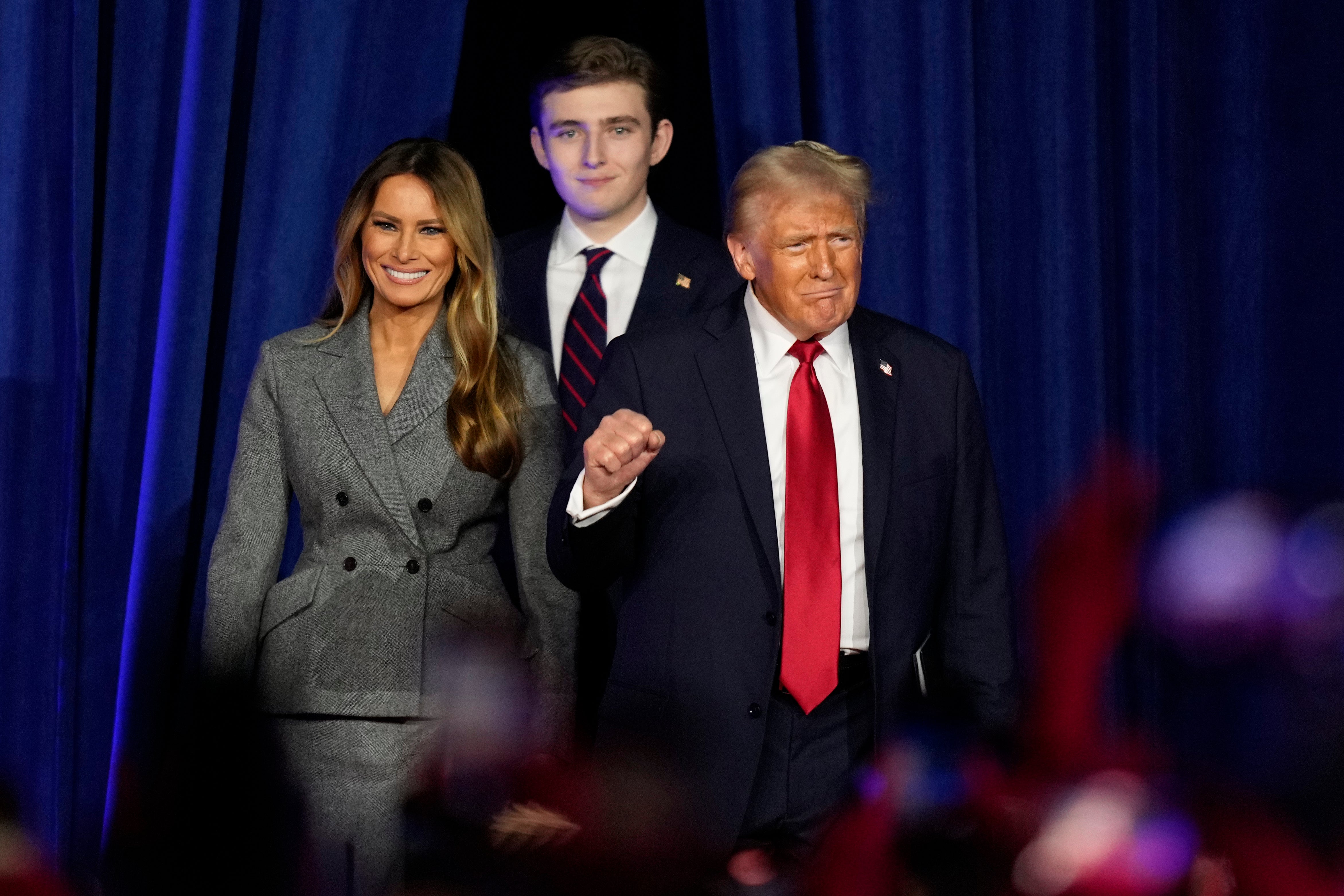 Donald Trump, joined by Melania Trump, left, and Barron Trump, arrives to speak at an election night watch party, Wednesday, Nov. 6, 2024, in West Palm Beach, Florida. Trump won Arizona, completing a sweep of all seven swing states this election