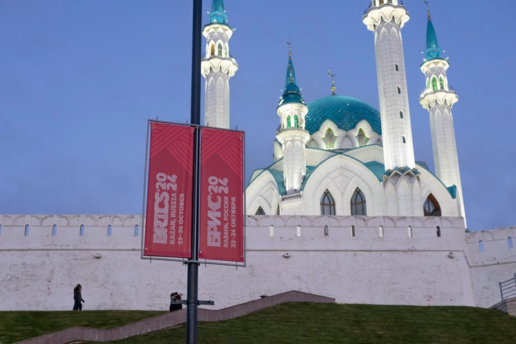 Kazan, Russia - October 18, 2024: BRICS 2024 Russia logo with the city of Kazan in the background. The upcoming summit where Brazil, Russia, India, China and South Africa will meet 