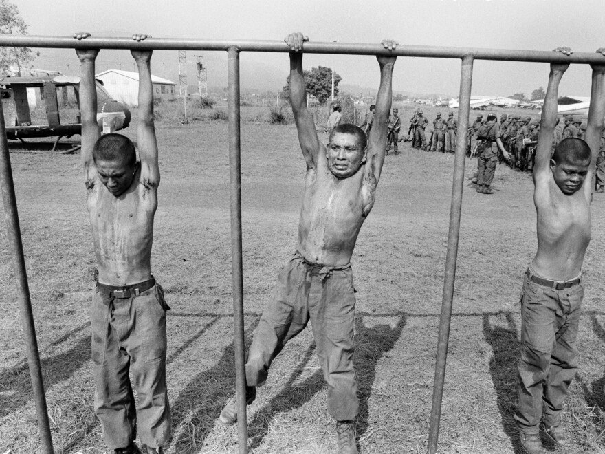 Salvadoran army recruits hang from a crossbar during a training exercise overseen by U.S. Army Rangers and Special Forces at the Ilopango air base in San Salvador, El Salvador, in March 1983.