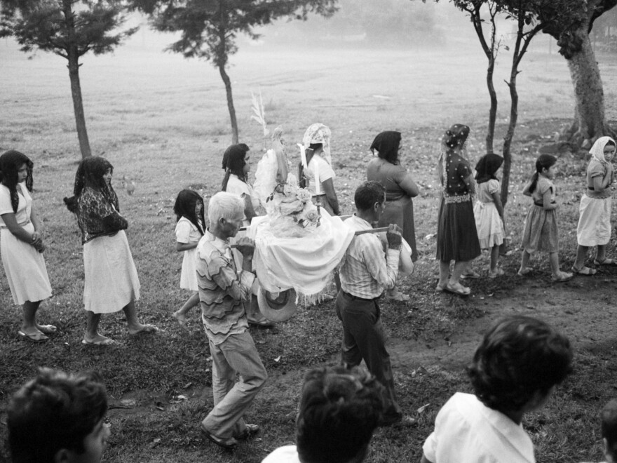 An altar with a statue of Jesus Christ is carried in a religious procession through the streets of Perquín, Morazán department, El Salvador, on Oct. 23, 1983.