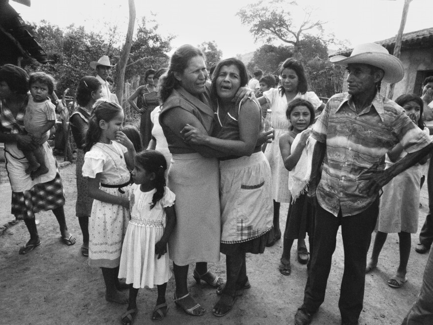 Local residents mourn as a truck carrying caskets of dead relatives arrives in Guadalupe, San Vicente department, El Salvador, on May 9, 1983.