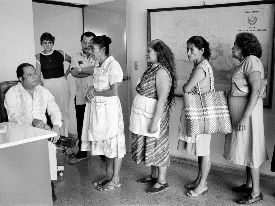 At the central office of the Salvadoran Human Rights Commission, a staff member (left) listens to women relay their cases regarding disappeared family members in San Salvador, El Salvador, in August 1983.