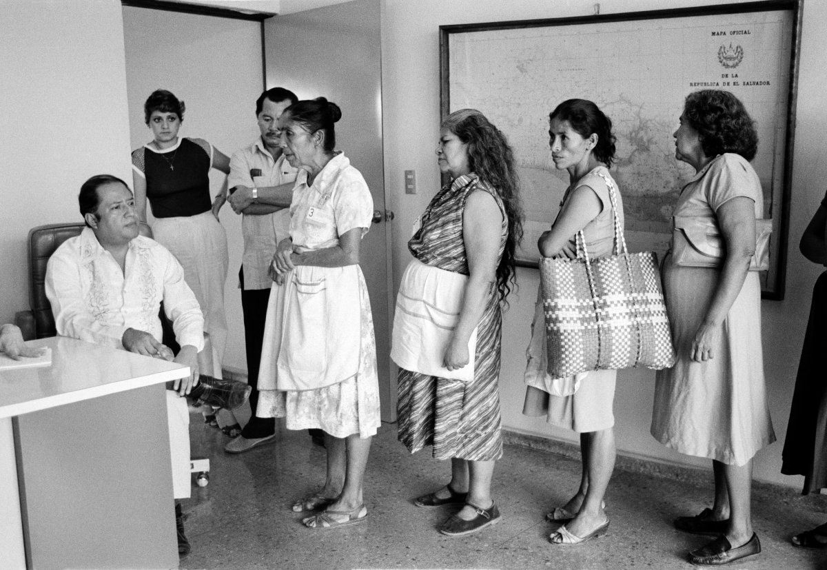 At the central office of the Salvadoran Human Rights Commission, a staff member (left) listens to women relay their cases regarding disappeared family members in San Salvador, El Salvador, in August 1983.