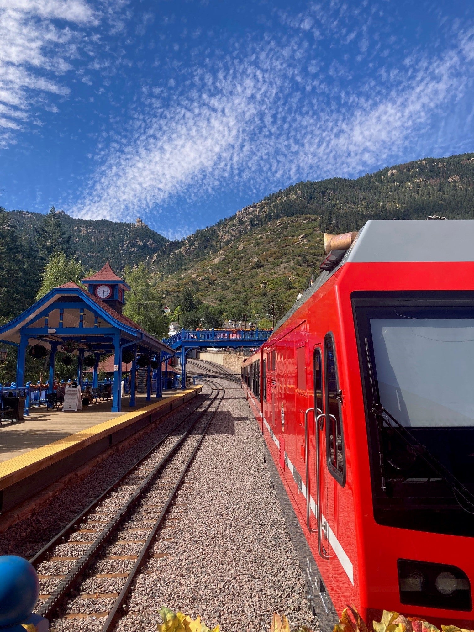 The bright-red cog railway train takes passengers slowly to the top of Pikes Peak