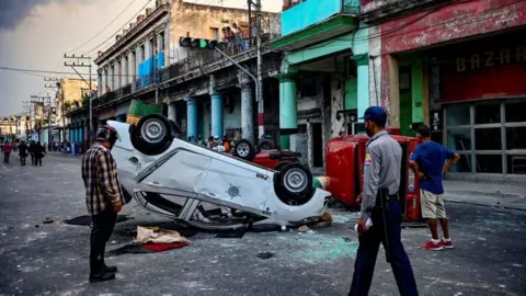 Getty Images Cars overturned by protesters in Havana, July 2021