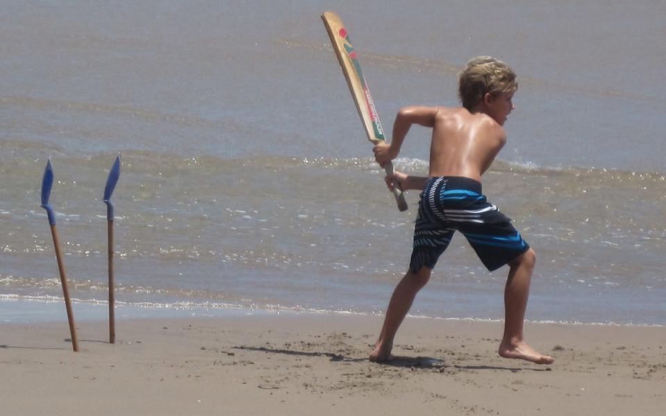 Jacob Bethell playing beach cricket in Barbados