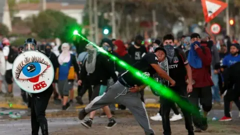 Reuters Demonstrators clash with riot police during a protest against Chile's government