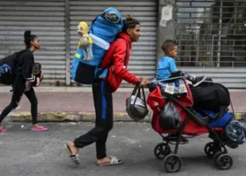 Getty Images A Venezuelan family heads to the Temporary Housing Center for Migrants San Antonio Casa Esperanza after walking for weeks in order to cross into Colombia and continue their journey to the United States, in San Antonio del Tachira, Venezuela, on September 25, 2022.
