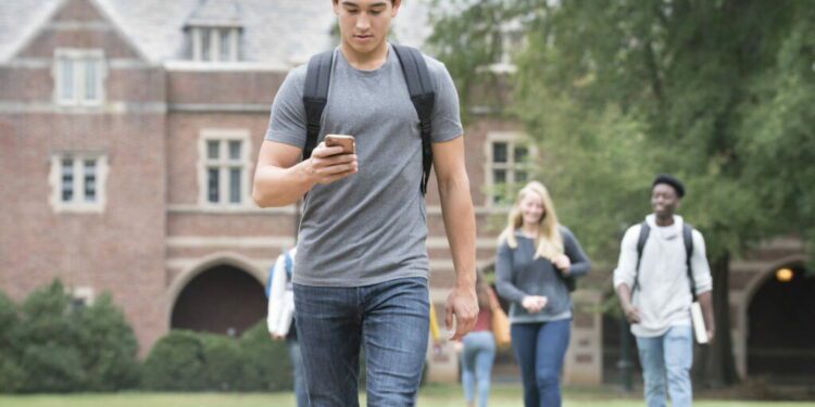 A student texts on a cellphone in this stock photo. (Ariel Skelley/Getty Images)