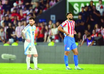 argentina s lionel messi and paraguay s omar alderete react during the 2026 fifa world cup south american qualifiers football match at the ueno defensores del chaco stadium photo afp