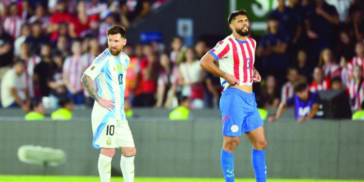 argentina s lionel messi and paraguay s omar alderete react during the 2026 fifa world cup south american qualifiers football match at the ueno defensores del chaco stadium photo afp