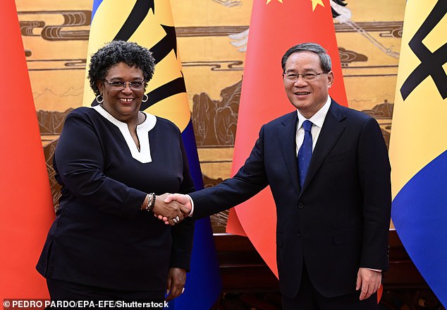 China's Premier Li Qiang (R) shakes hands with Barbados Prime Minister Mia Mottley at the Great Hall of the People in Beijing, China, in June 2023