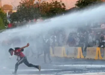 Reuters Police fire water cannon at protesters