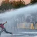 Reuters Police fire water cannon at protesters
