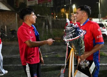 Hector Sanchez (R) and Edison Flores, who received organ transplants, pose with the Transplant Football World Cup trophy during a training session with of the Chilean transplanted football team in Santiago