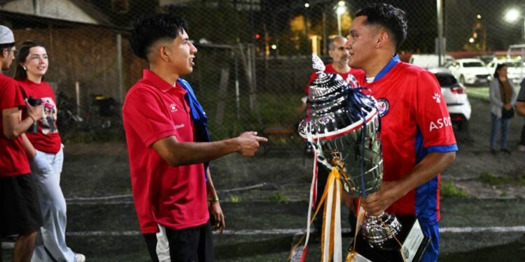 Hector Sanchez (R) and Edison Flores, who received organ transplants, pose with the Transplant Football World Cup trophy during a training session with of the Chilean transplanted football team in Santiago
