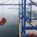 A drone view shows a crane moving a container at the new megaport being built by China's state-owned Cosco Shipping, in Ch...