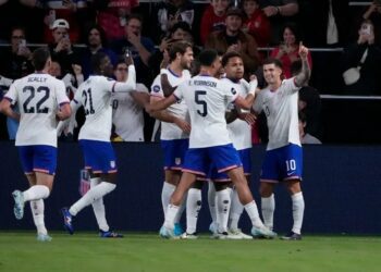 Christian Pulisic (right) is congratulated by teammates after scoring one of his goals in Monday's game.