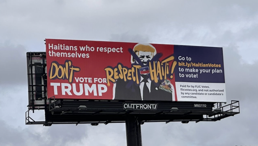 A billboard urges Haitian-Americans not to to vote for former President Donald Trump